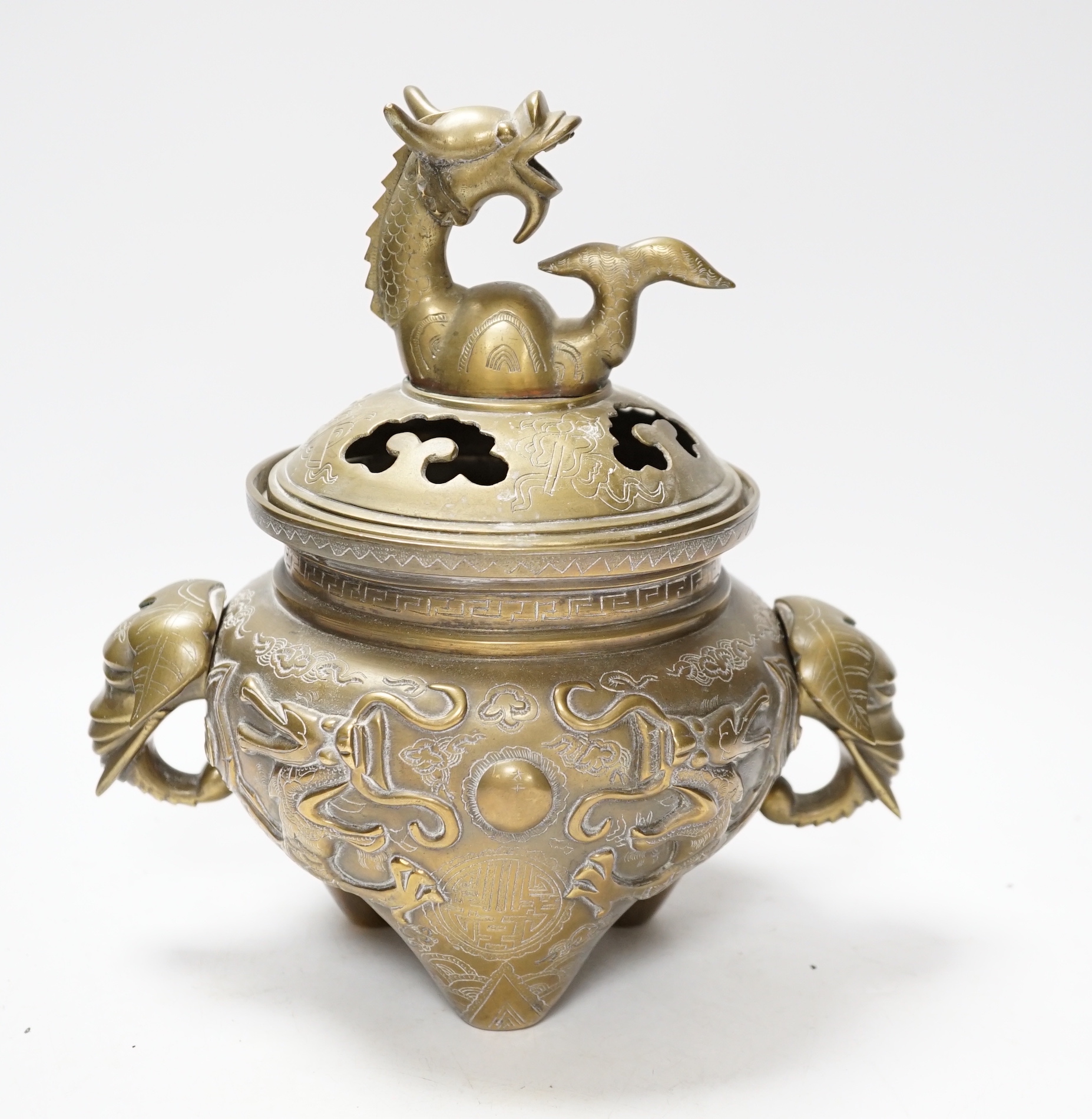 A Chinese bronze ‘dragon’ tripod censer and cover, 24cm